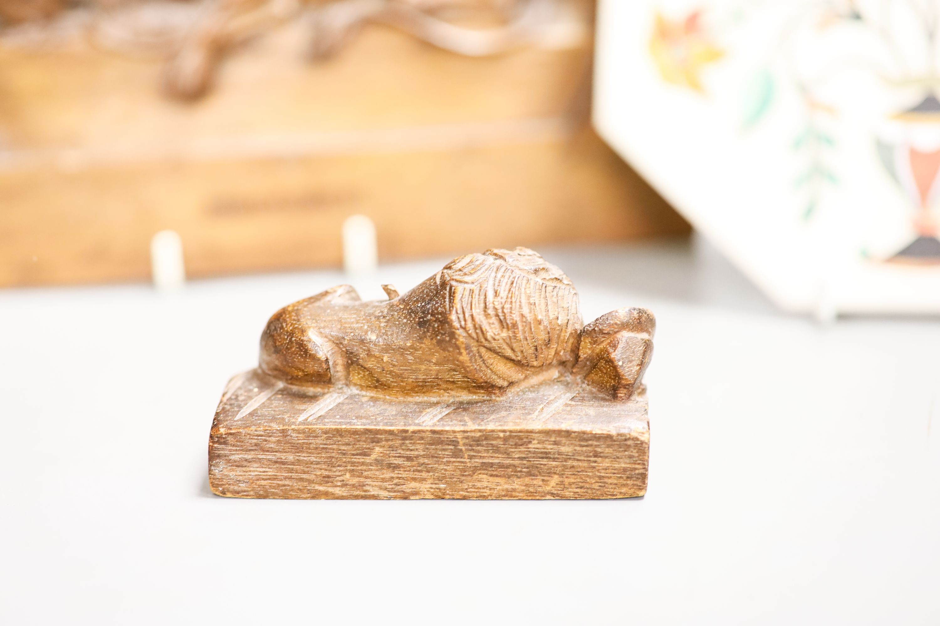 A walnut Lion of Lucerne plaque and carving and an Indian hardstone plaque